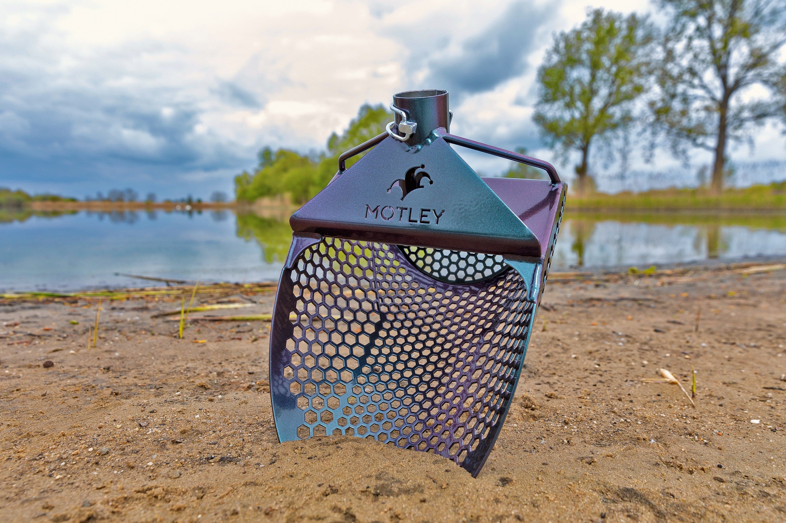 Motley Beach Scoop in chameleon color-shift finish on a lakeside beach
