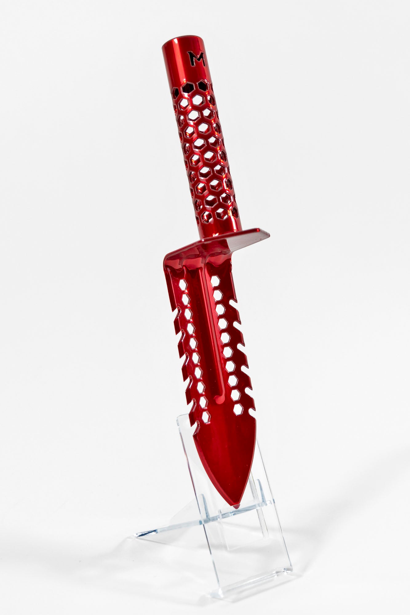 Motley Grass Knife in Red Raven with hexagon laser cut handle and cutting teeth on both sides