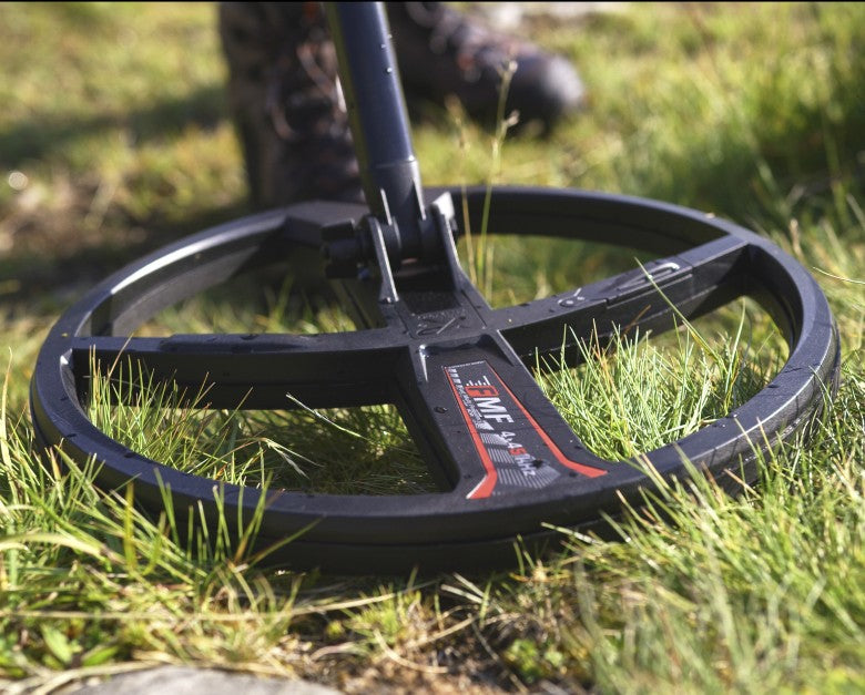 Ground-level view of the XP 11 inch FMF coil on a Deus II working short grass
