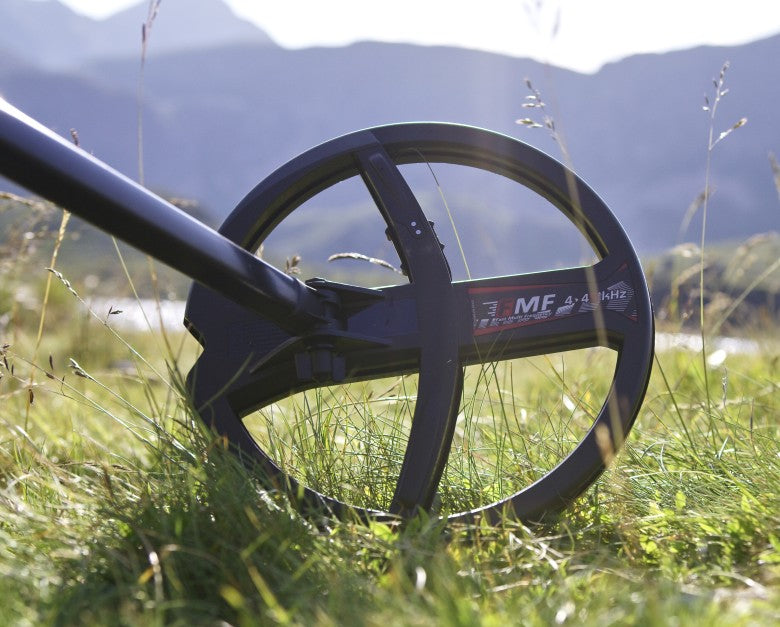 Close-up of an XP FMF search coil for the Deus II in mountain grass