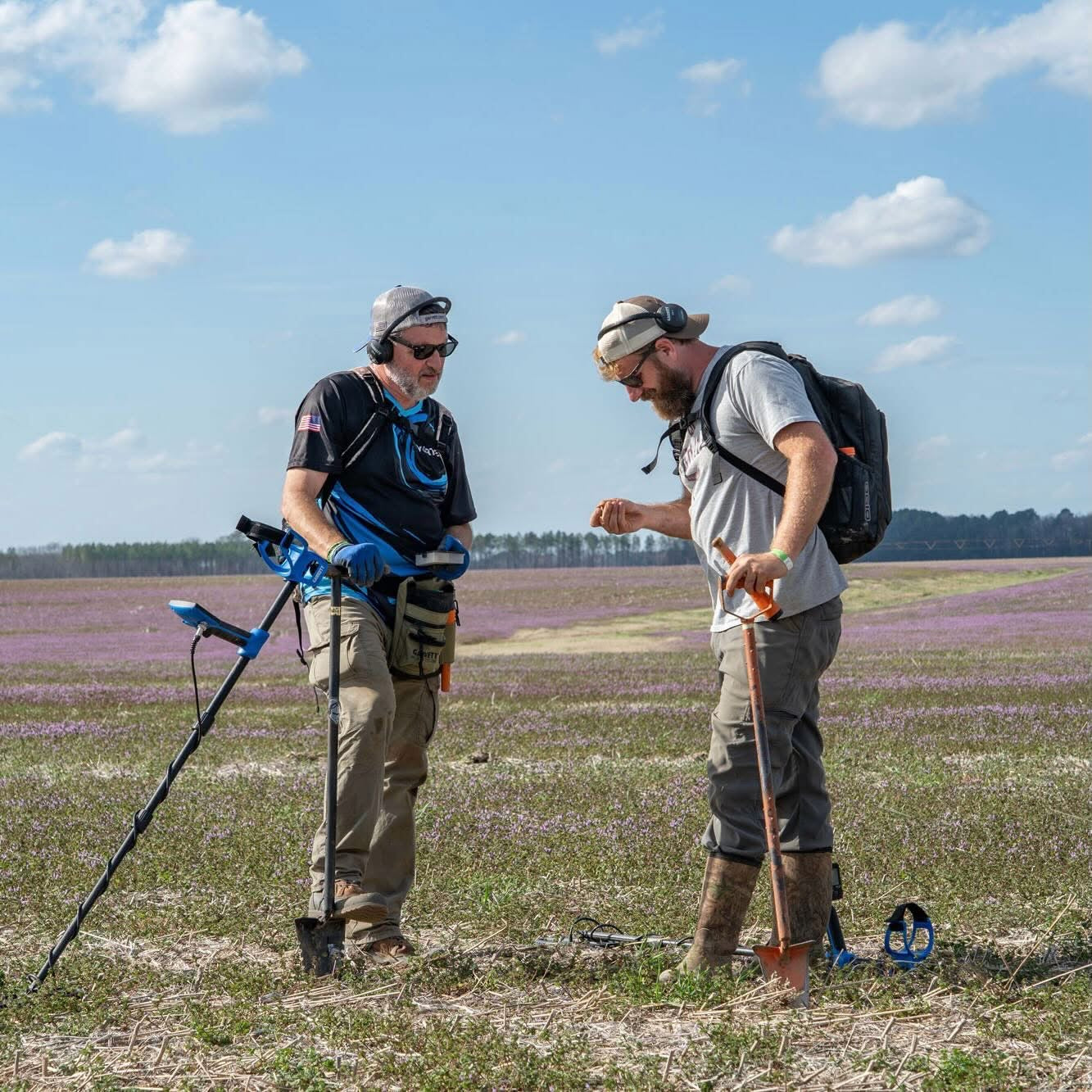 Brandon Nicholas of Adventure Archaeology metal detecting in a field with the Garrett Vortex VX9
