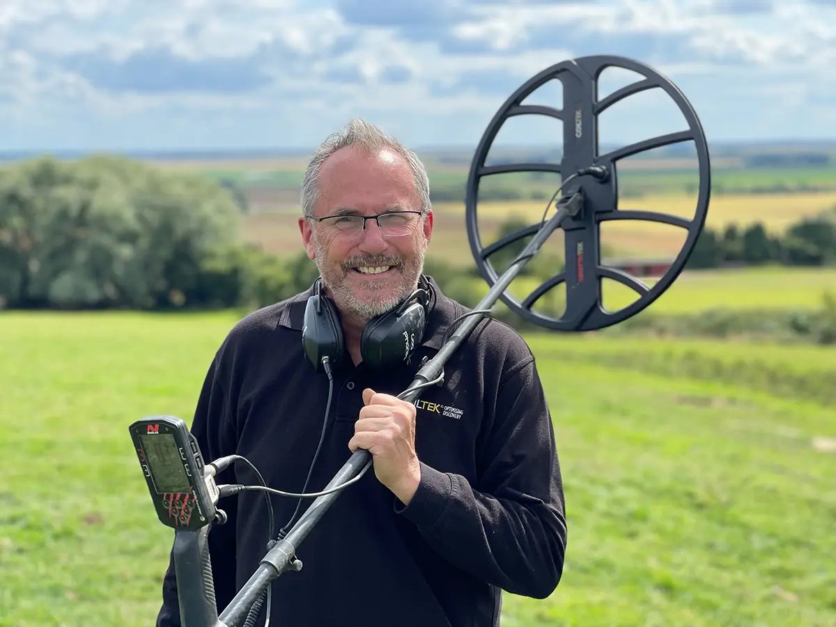 Detectorist in an open field with a Minelab Manticore fitted with the Coiltek 18 inch Mythtek coil