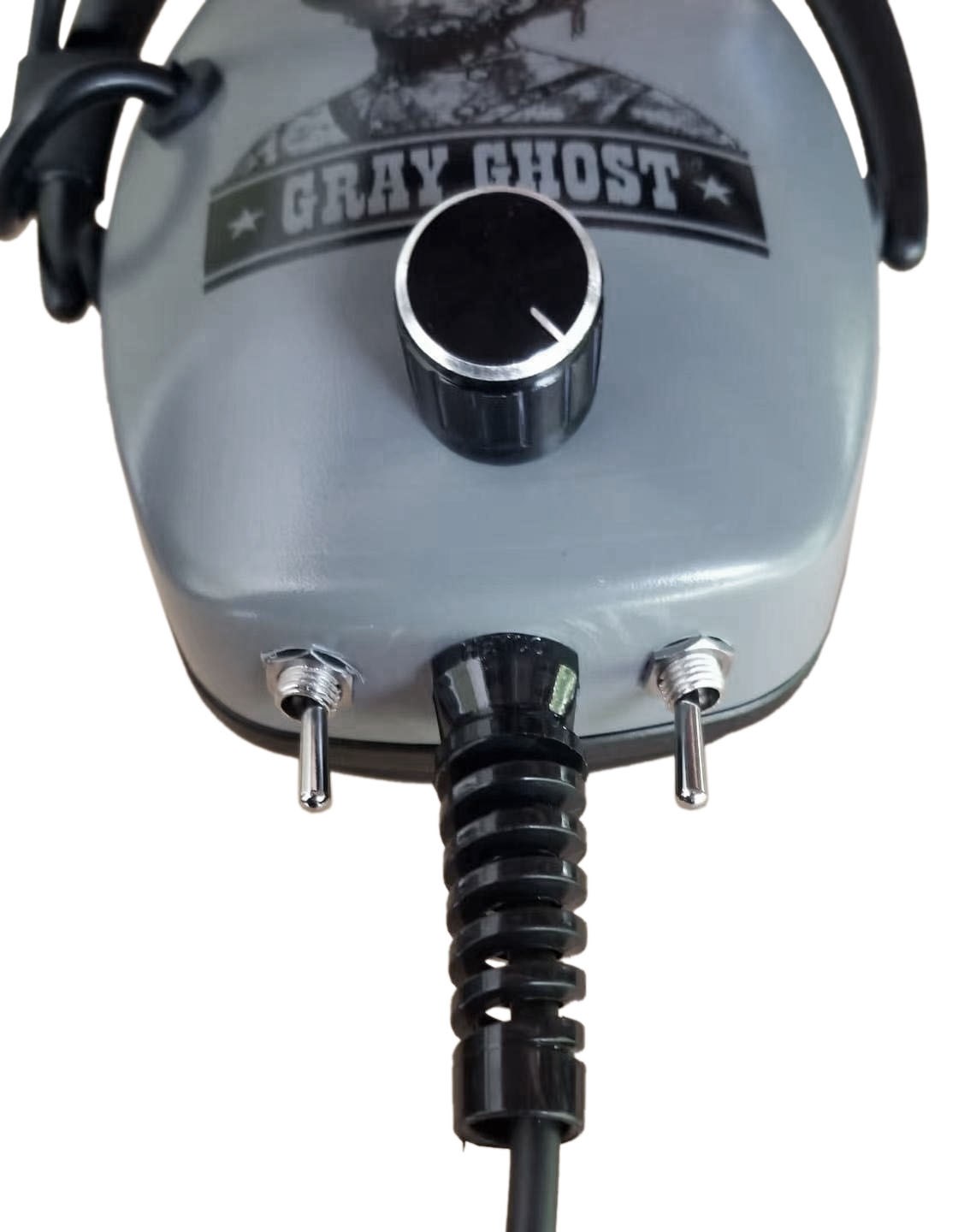 Gray Ghost Ultimate headphone underside showing coiled cord strain relief and compatibility and limiter toggles