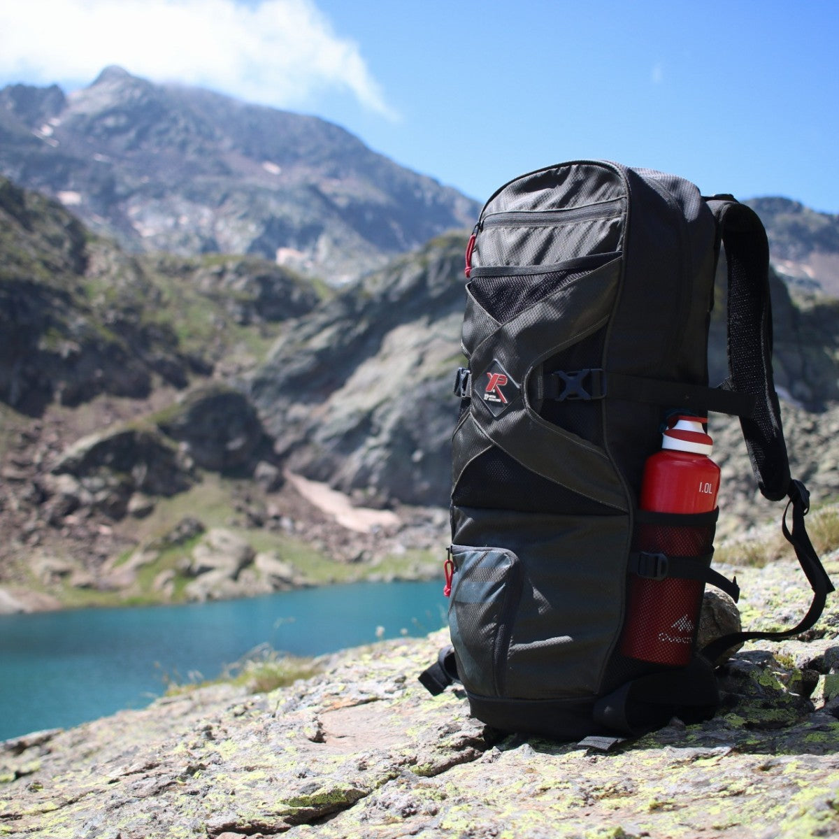 XP Backpack 240 in the field on a mountain trail with bottle in side pocket